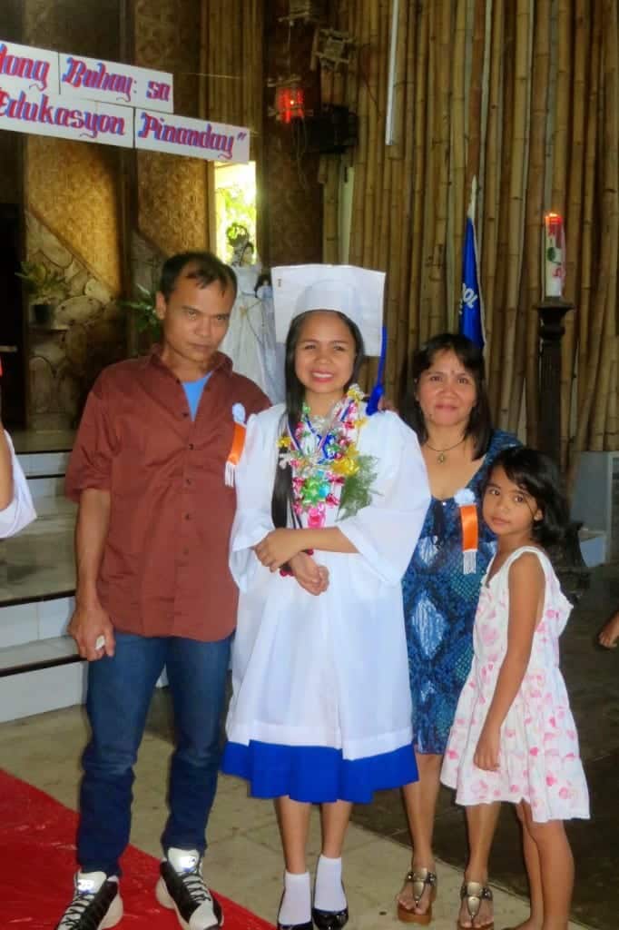 Elza, class salutatorian, and her proud parents at graduation. 