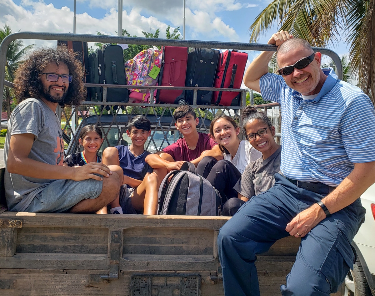 Mission trippers riding in the back of a truck