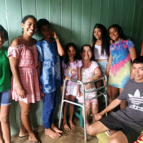 Sarai and family Sarai (2nd from the left) standing in their living room with her mother and her six kids